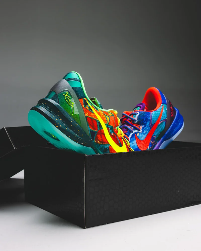 Colorful Kobe sneakers resting in an open black shoebox at Common Hype.